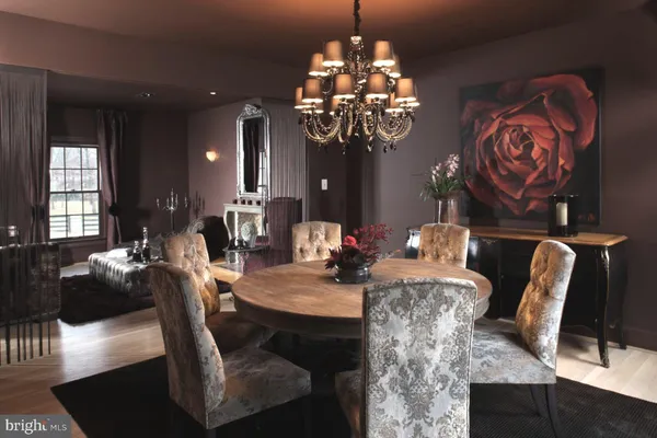 a view of a dining room with furniture wooden floor and chandelier