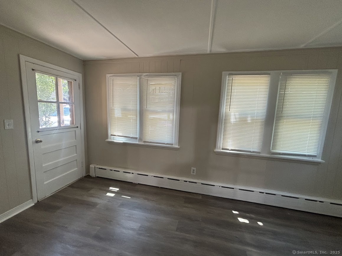 156 River Rd Extension, Unit 2 Greenwich, CT 06807 - Photo 11 of 15 an empty room with wooden floor and windows