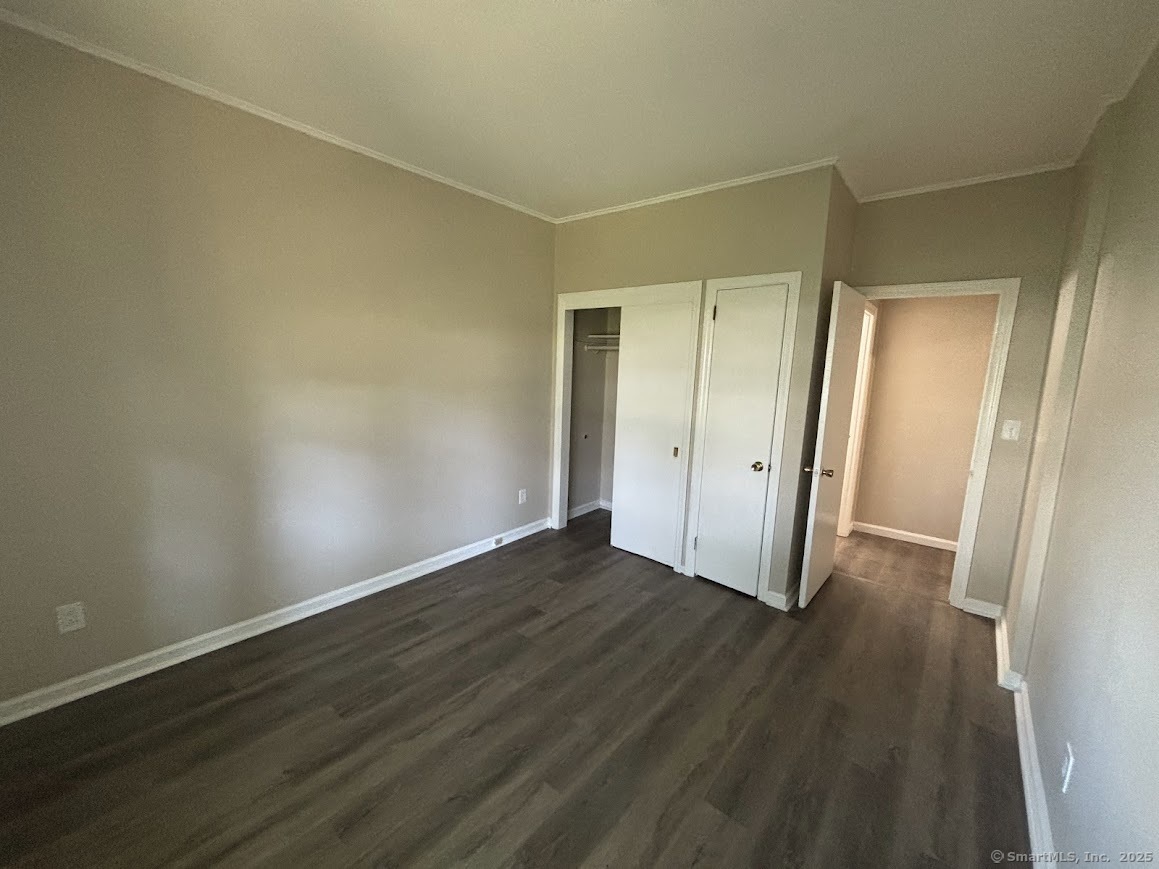 156 River Rd Extension, Unit 2 Greenwich, CT 06807 - Photo 12 of 15 an empty room with wooden floor and a door