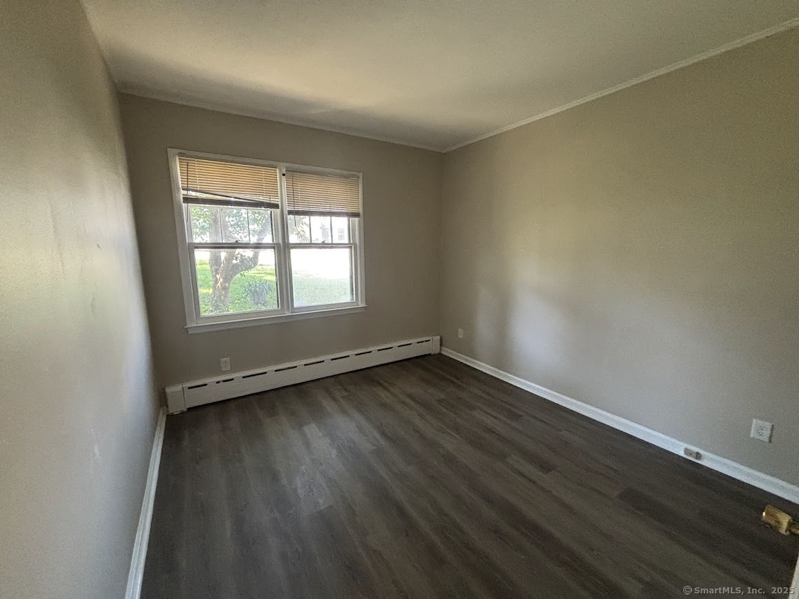 156 River Rd Extension, Unit 2 Greenwich, CT 06807 - Photo 13 of 15 an empty room with wooden floor and windows
