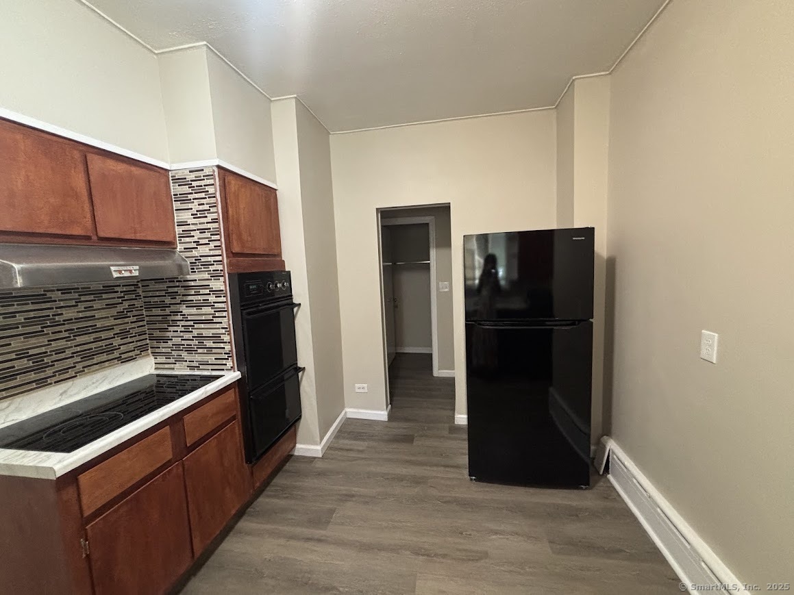 156 River Rd Extension, Unit 2 Greenwich, CT 06807 - Photo 3 of 15 a kitchen with a refrigerator and a stove