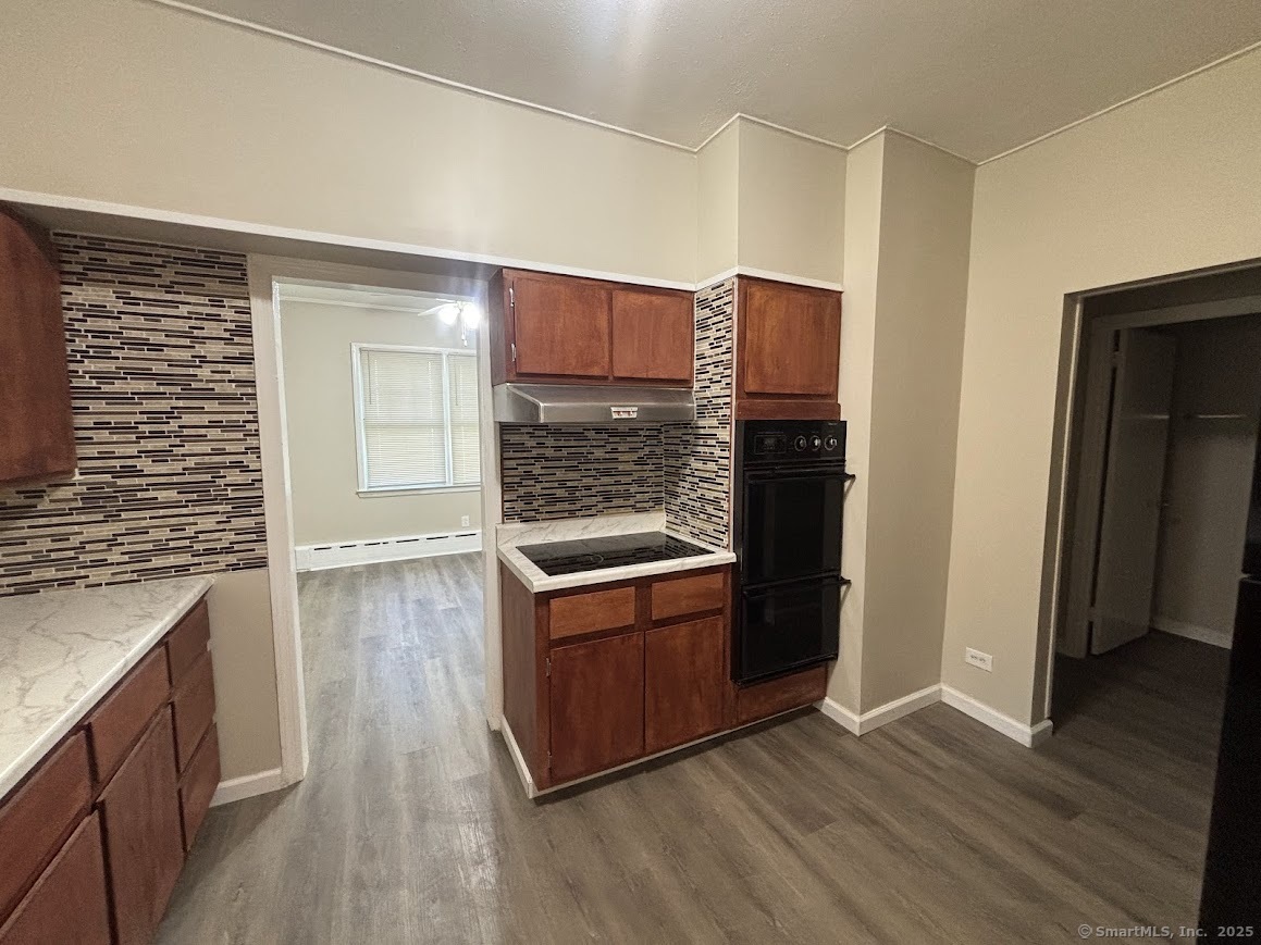 156 River Rd Extension, Unit 2 Greenwich, CT 06807 - Photo 4 of 15 an empty room with wooden floor and entrance