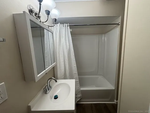 a bathroom with a sink a mirror and a bathtub
