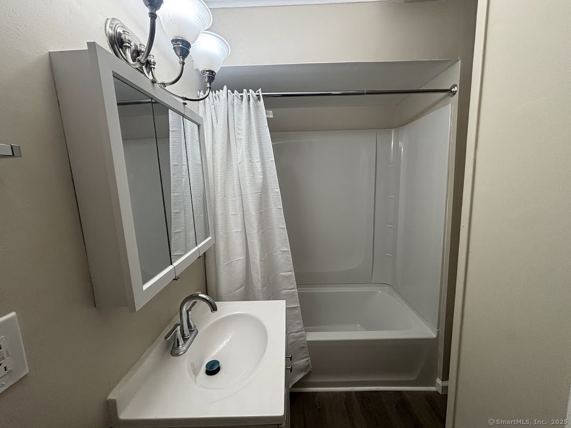 156 River Rd Extension, Unit 2 Greenwich, CT 06807 - Photo 6 of 15 a bathroom with a sink a mirror and a bathtub