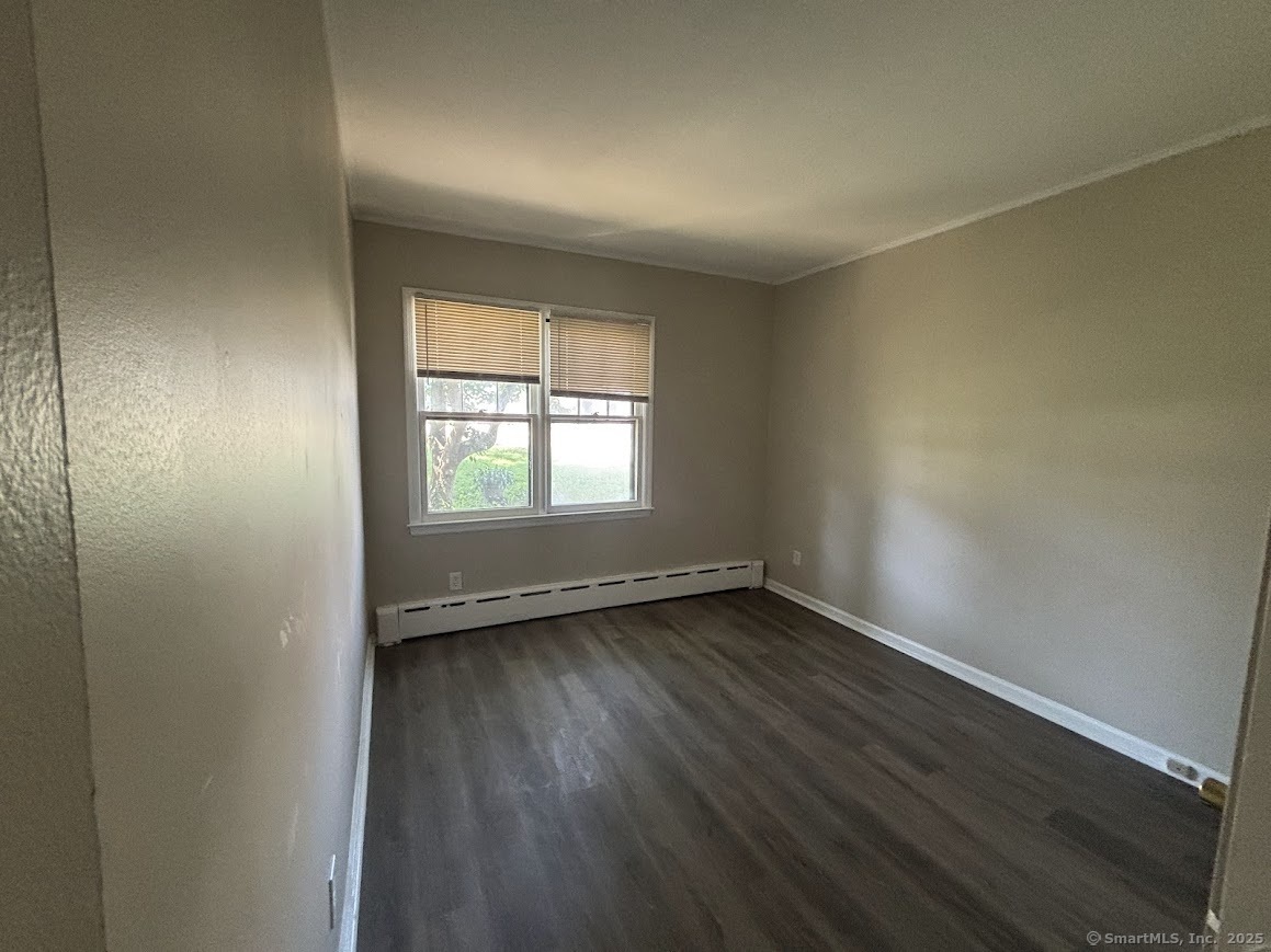 156 River Rd Extension, Unit 2 Greenwich, CT 06807 - Photo 9 of 15 an empty room with wooden floor and windows