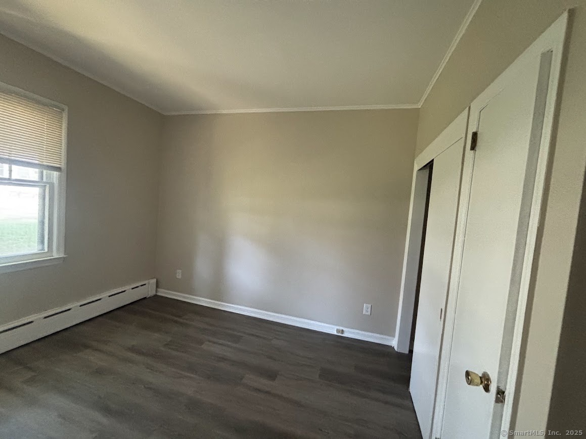 156 River Rd Extension, Unit 2 Greenwich, CT 06807 - Photo 10 of 15 an empty room with wooden floor and window