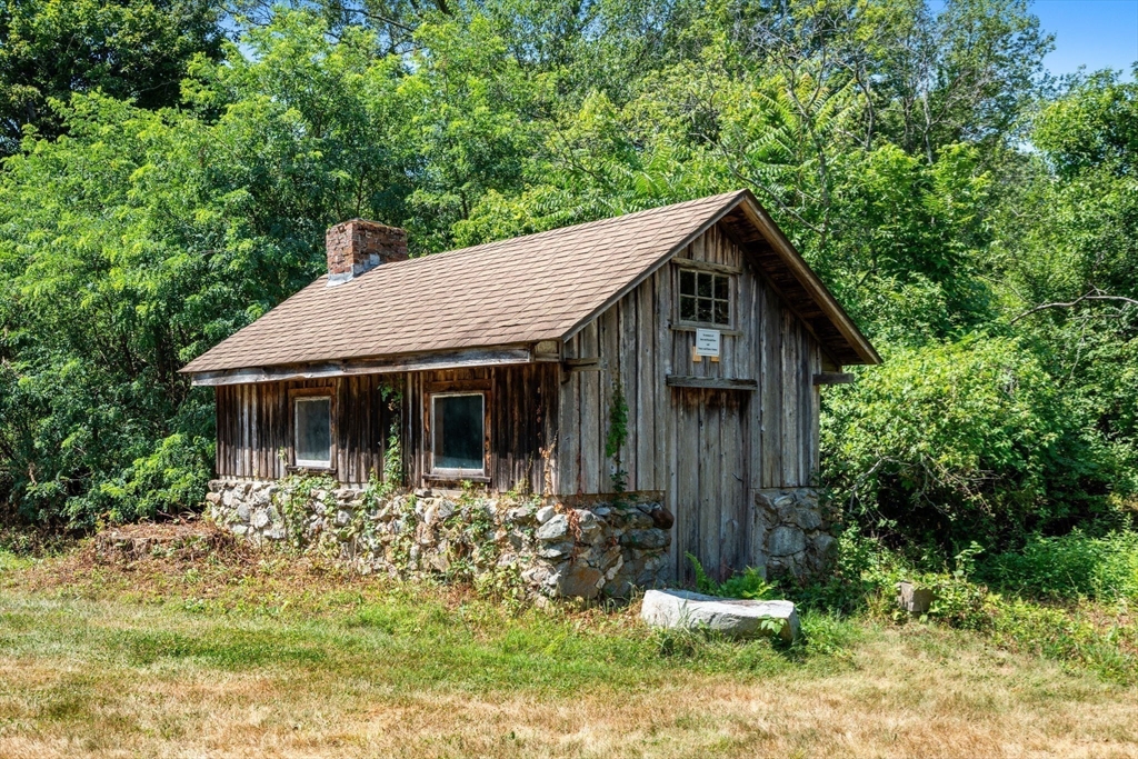 145 Tower Road Lincoln, MA 01773 - Photo 23 of 26 a front view of a house with garden