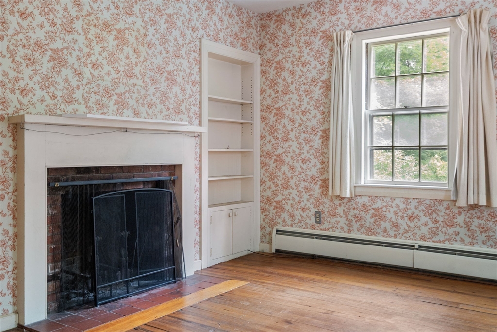 145 Tower Road Lincoln, MA 01773 - Photo 4 of 26 a view of an empty room with wooden floor and a window
