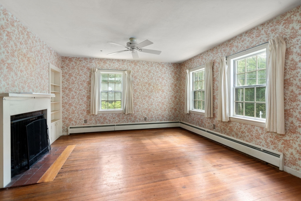 145 Tower Road Lincoln, MA 01773 - Photo 5 of 26 a view of an empty room with window and fire place
