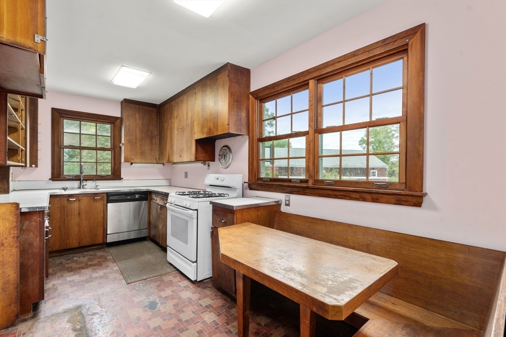 145 Tower Road Lincoln, MA 01773 - Photo 9 of 26 a kitchen with a stove a sink and a refrigerator