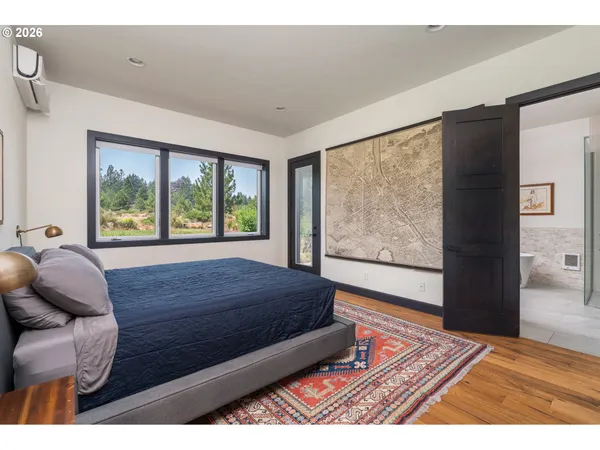 a living room with a bed furniture and next to a window