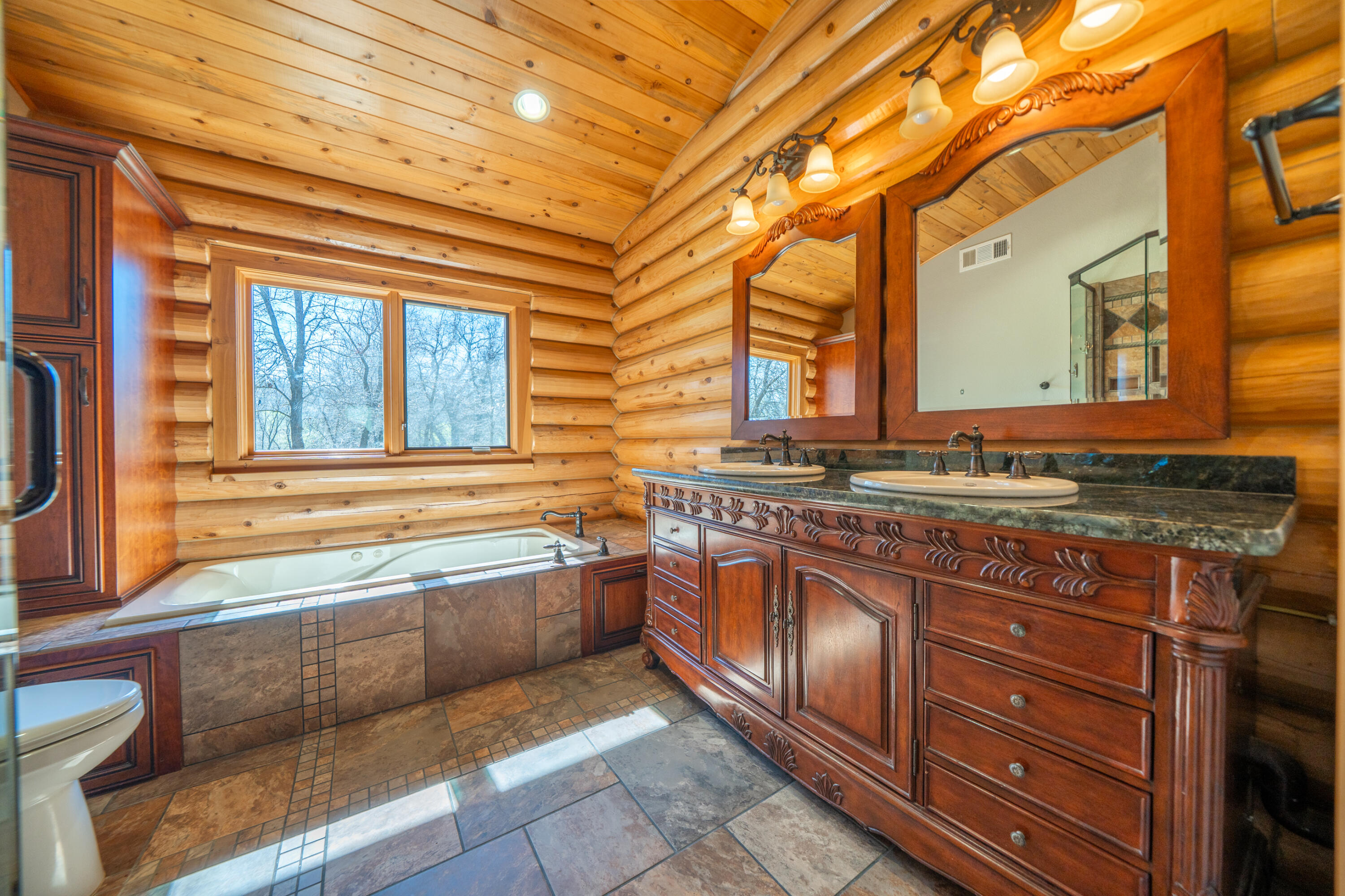 11875 Oak Run Road Oak Run, CA 96069 - Photo 21 of 127 a bathroom with a granite countertop sink and large windows