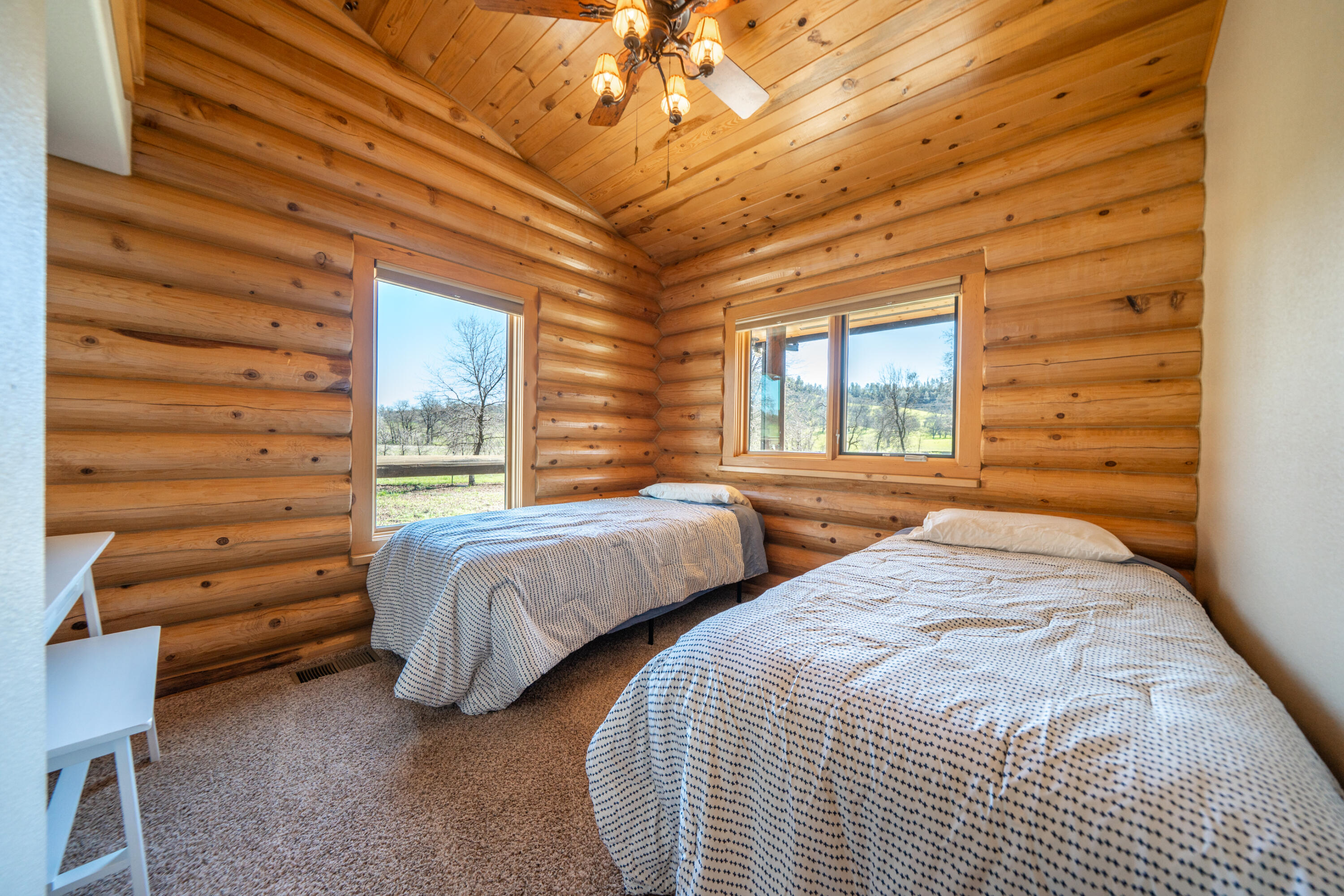 11875 Oak Run Road Oak Run, CA 96069 - Photo 26 of 127 a bedroom with two beds and a chandelier