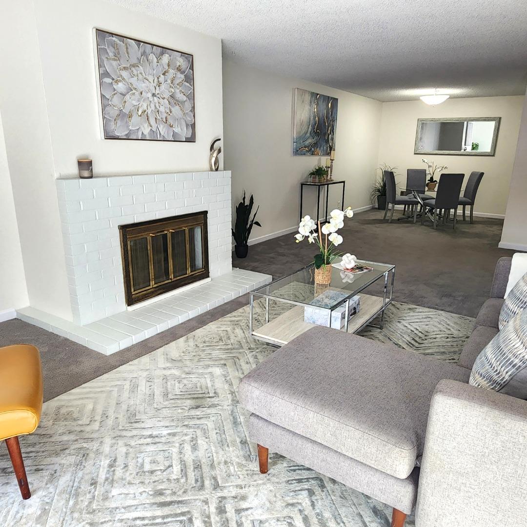 a living room with furniture and a fireplace