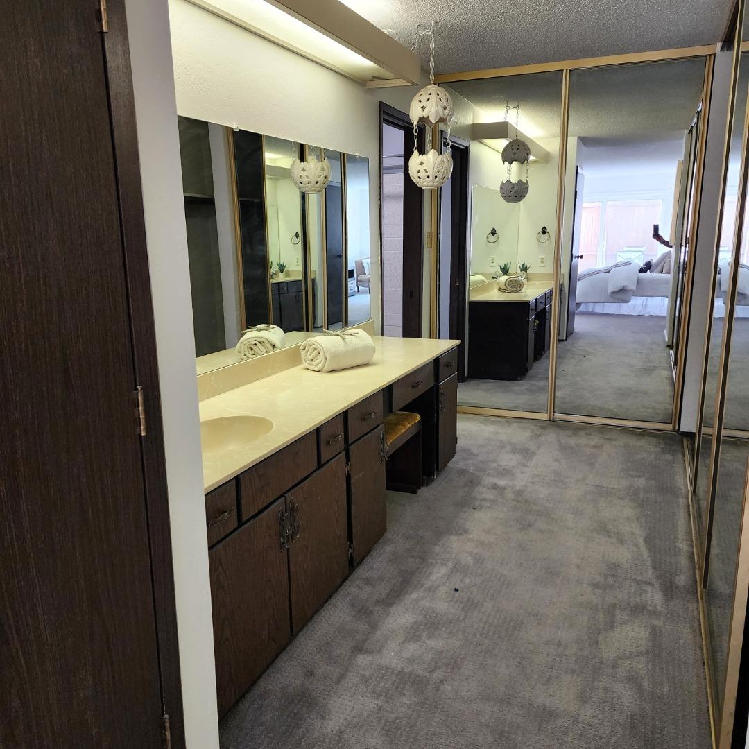 1500 Broadway, Unit 205 Burlingame, CA 94010 - Photo 16 of 24 a spacious bathroom with a mirror a sink and a shower