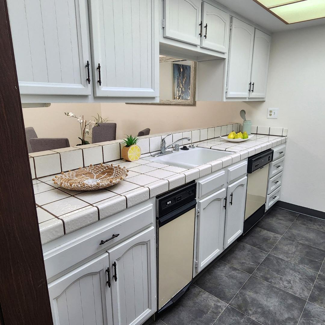 1500 Broadway, Unit 205 Burlingame, CA 94010 - Photo 6 of 24 a kitchen with a sink stove and cabinets