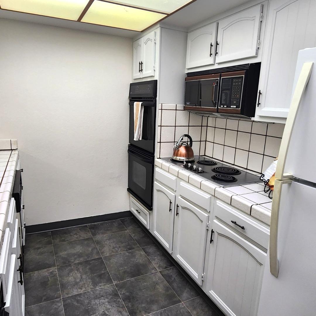 1500 Broadway, Unit 205 Burlingame, CA 94010 - Photo 7 of 24 a kitchen with a refrigerator and a sink