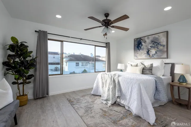 a spacious bedroom with a bed and a window