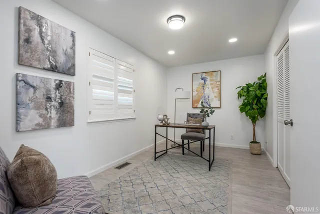 a view of a workspace with furniture and a potted plant