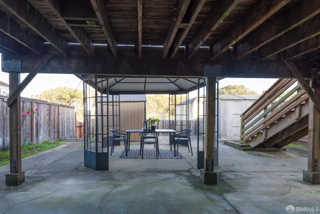 a view of a porch with furniture and a yard