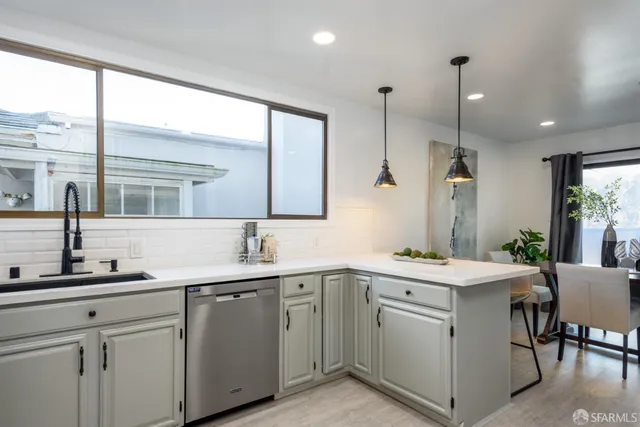 a kitchen with a sink stove and cabinets