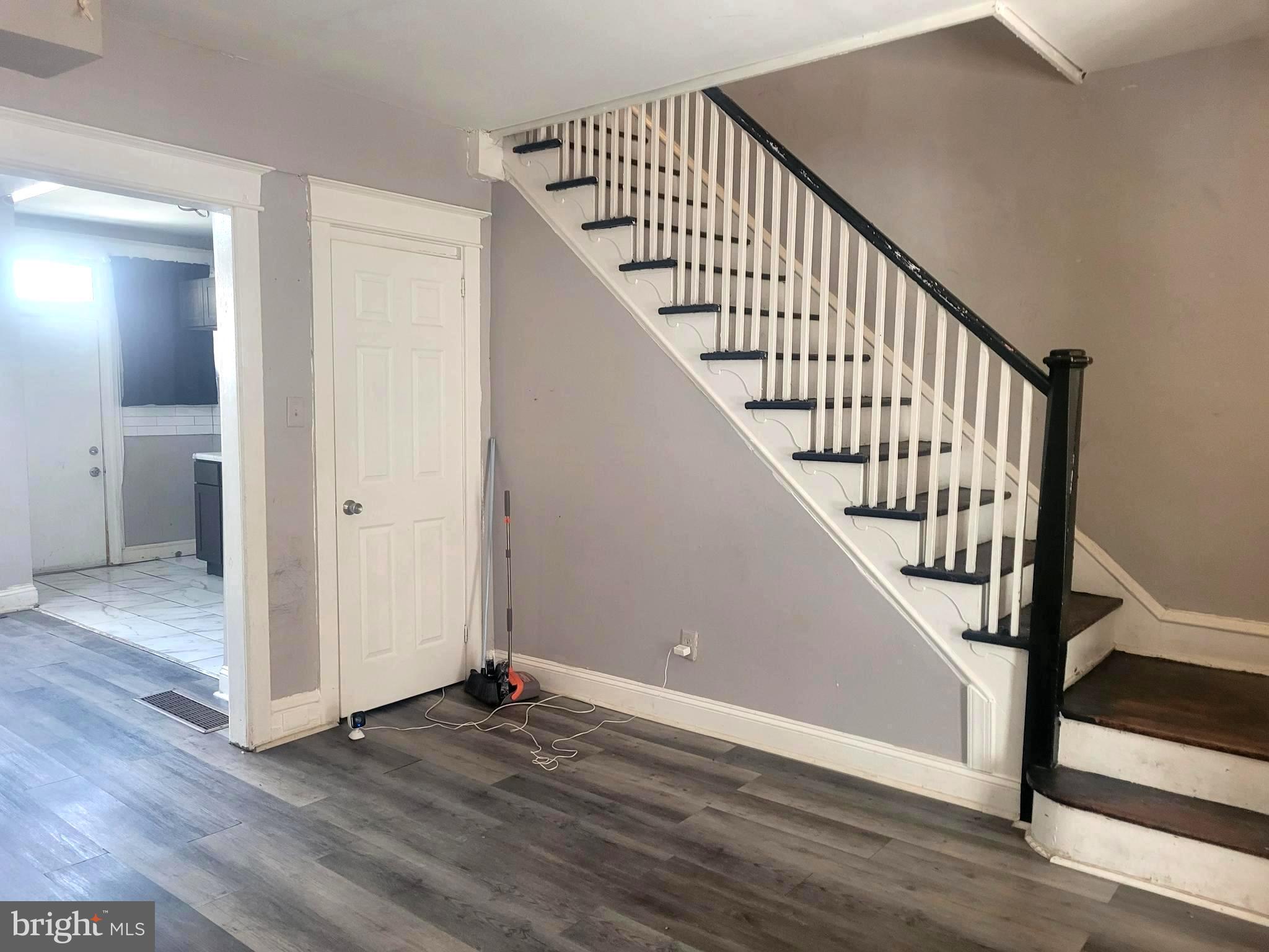 a view of an entryway with wooden floor