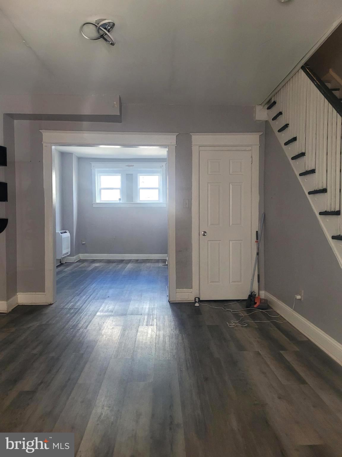 5563 Blakemore Street Philadelphia, PA 19138 - Photo 2 of 14 wooden floor in an empty room with a window