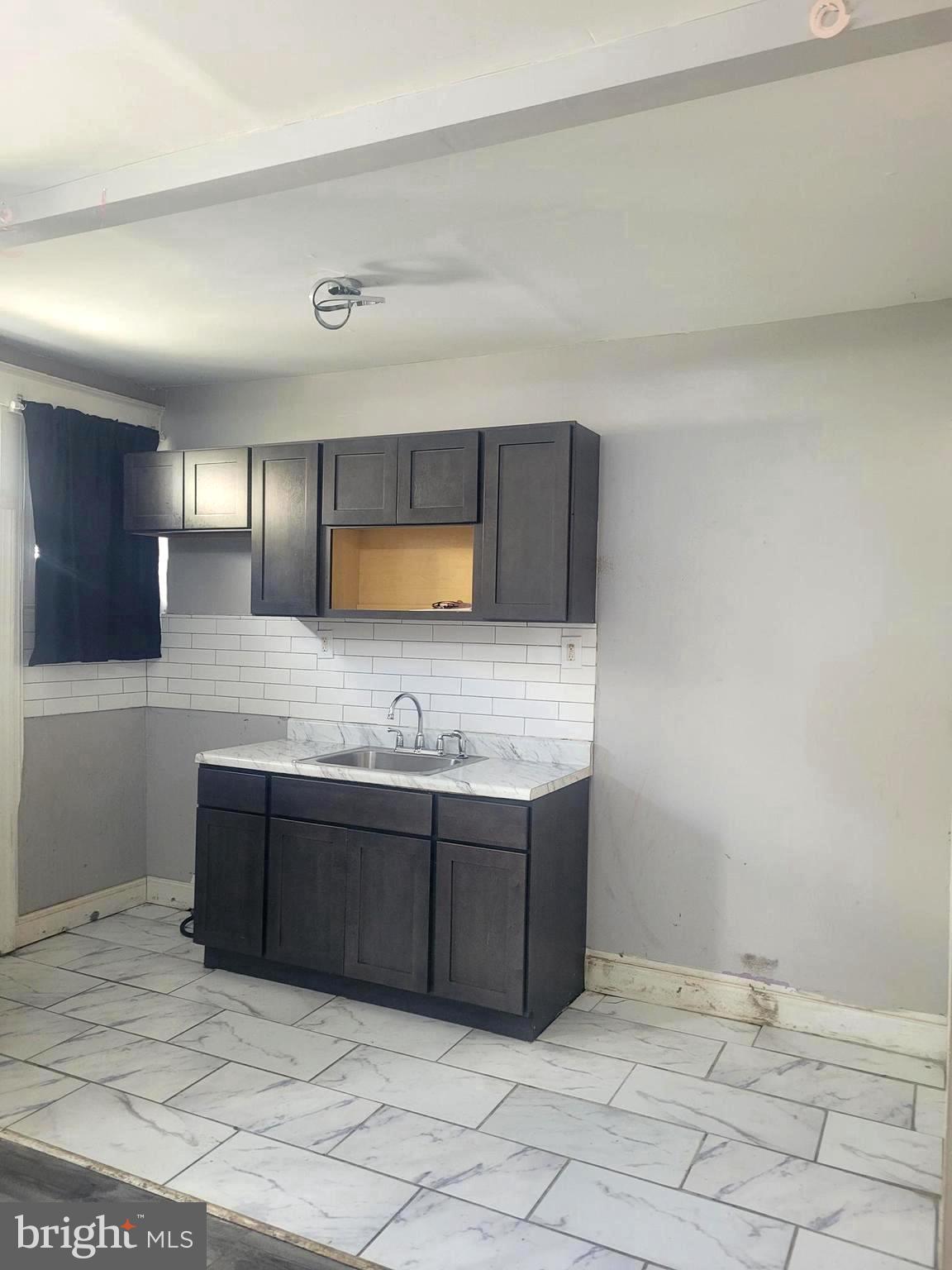 5563 Blakemore Street Philadelphia, PA 19138 - Photo 5 of 14 a bathroom with a sink and mirror