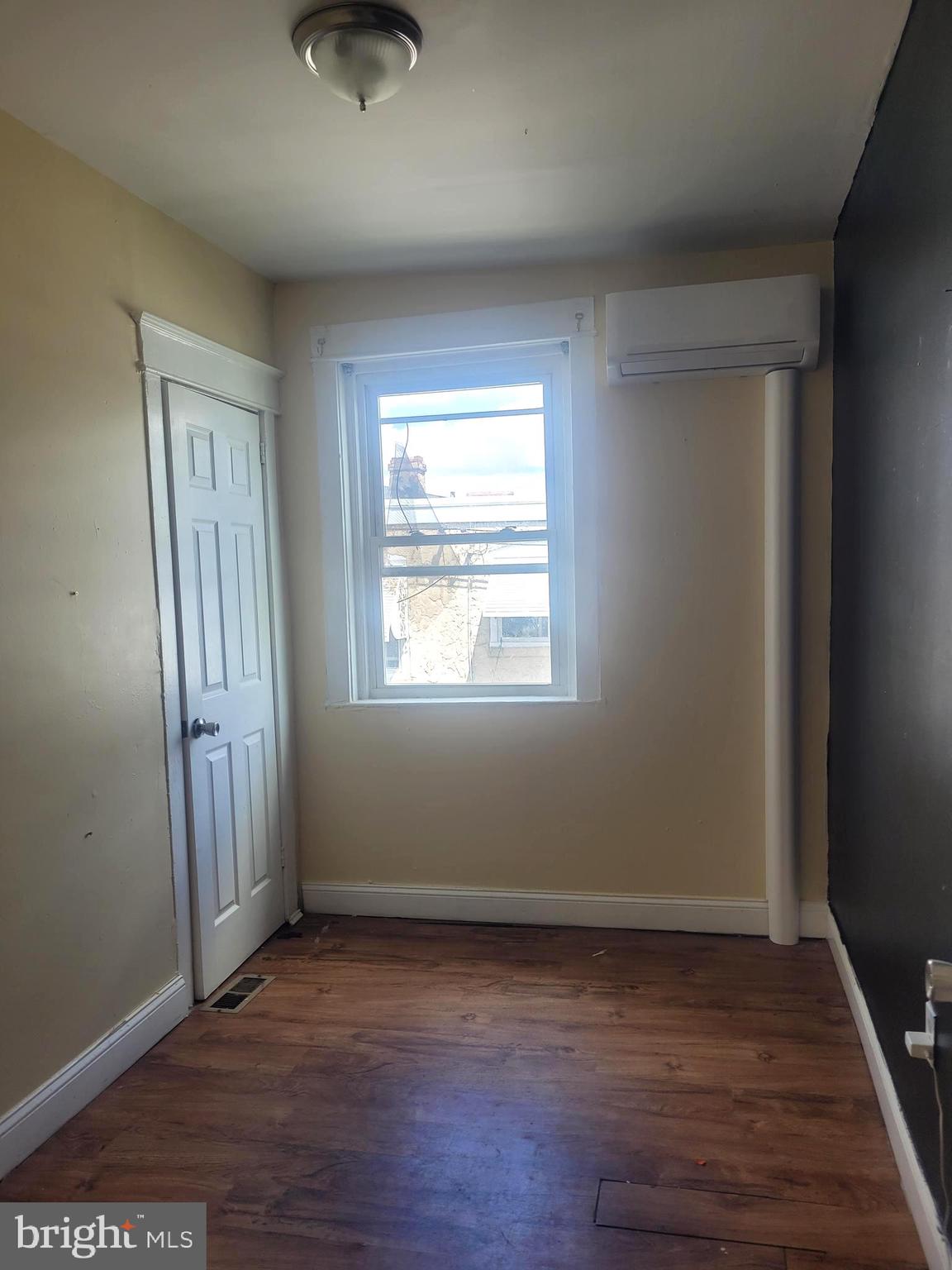 5563 Blakemore Street Philadelphia, PA 19138 - Photo 6 of 14 an empty room with wooden floor and windows