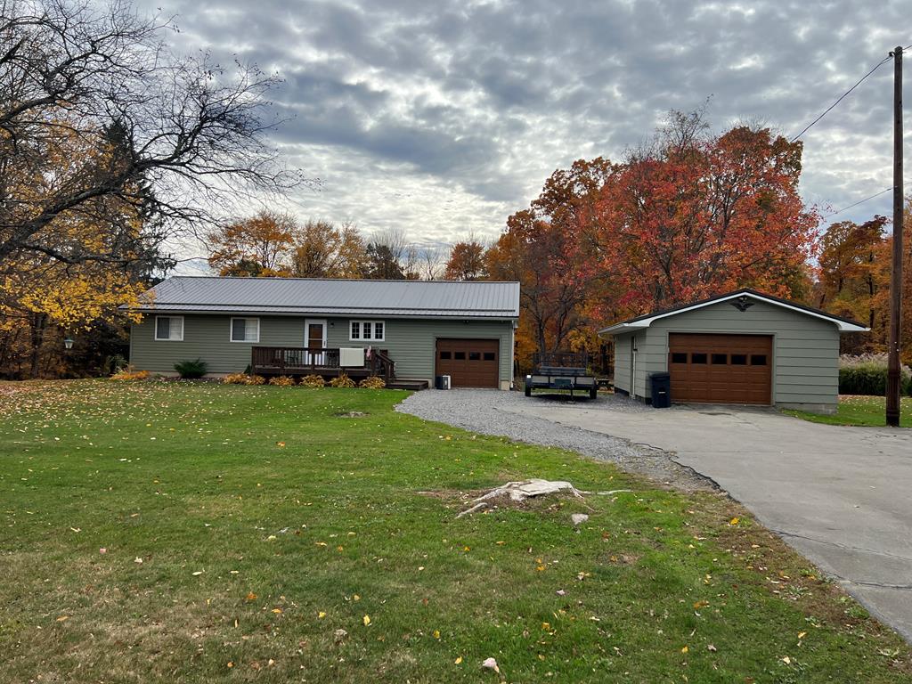 3958 Georgetown Road Polk, PA 16342 - Photo 1 of 20 a front view of a house with a garden