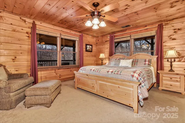 a large bedroom with a large bed and a chandelier