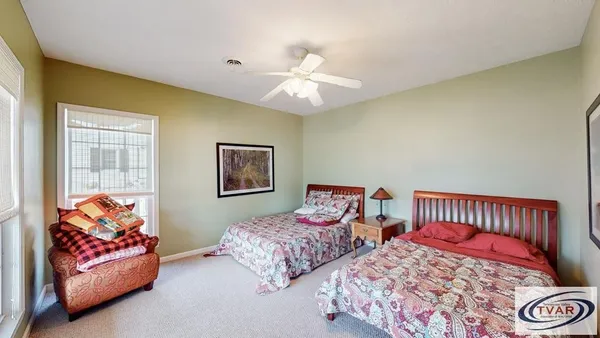 a bedroom with two beds and a chandelier