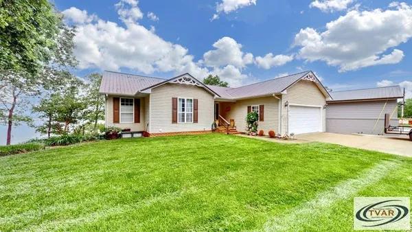 a view of a house with a backyard