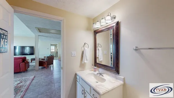 a bathroom with a sink vanity and a mirror