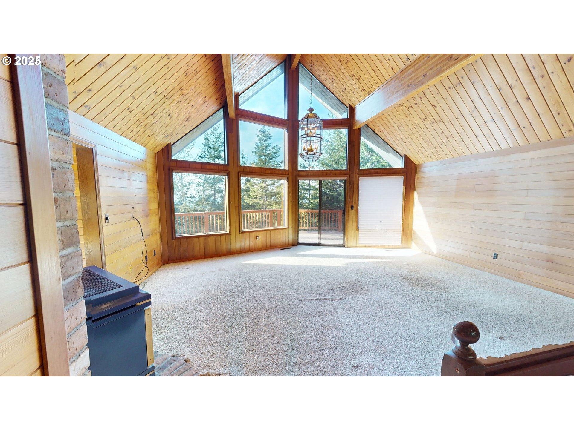 95107 Welsh Drive Gold Beach, OR 97444 - Photo 2 of 48 a living room with a balcony furniture and a large window