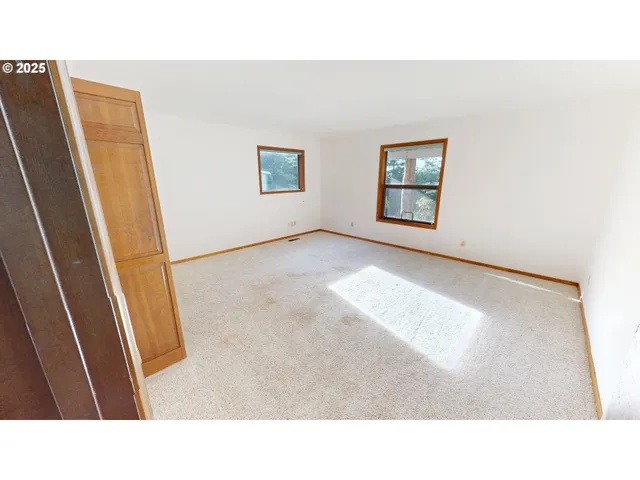 a room with large windows and stairs