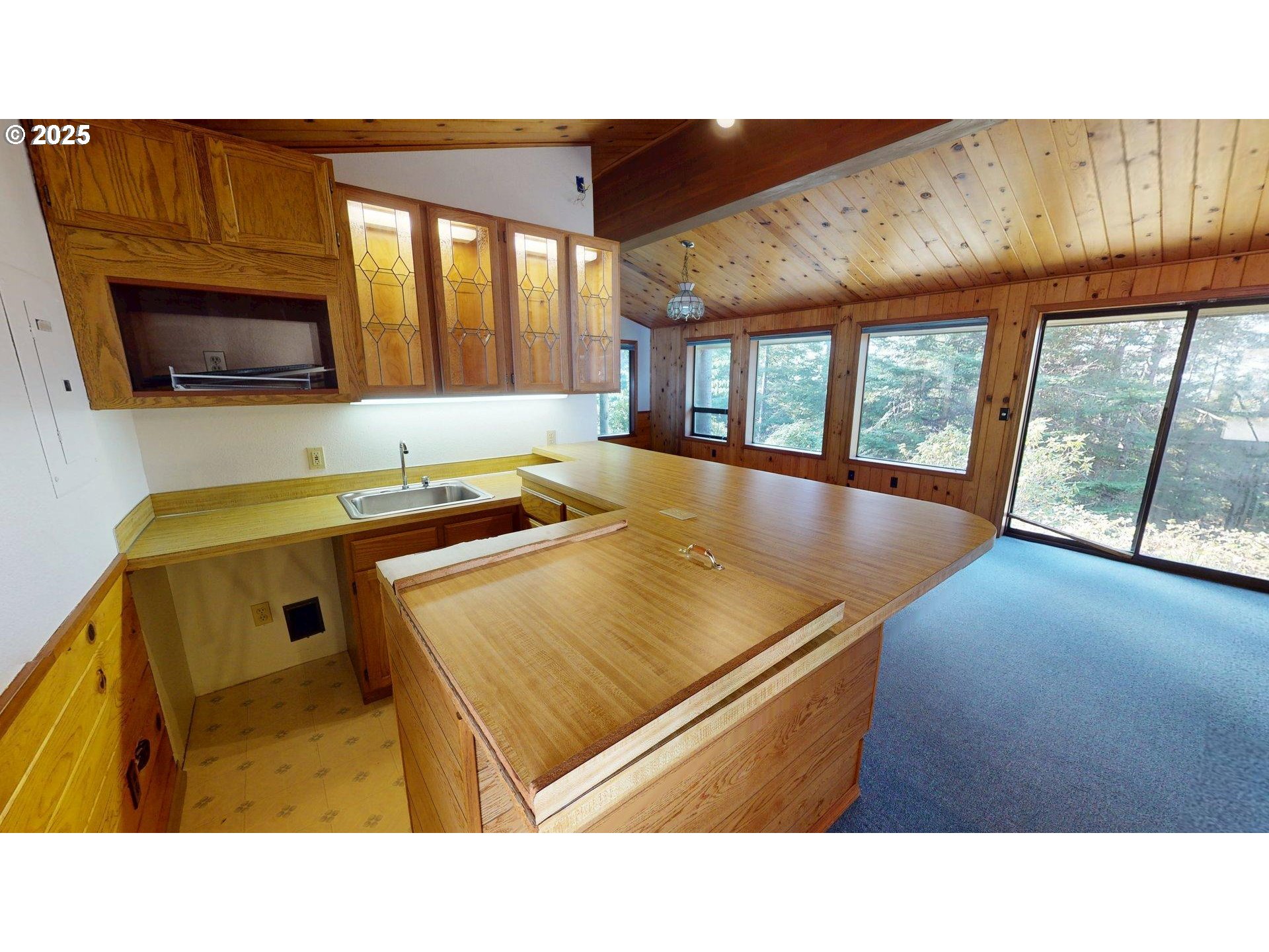 95107 Welsh Drive Gold Beach, OR 97444 - Photo 38 of 48 a open kitchen with stainless steel appliances kitchen island granite countertop a sink and cabinets