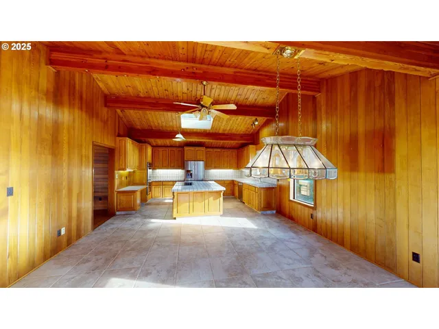 a kitchen with stainless steel appliances a stove a sink and a microwave