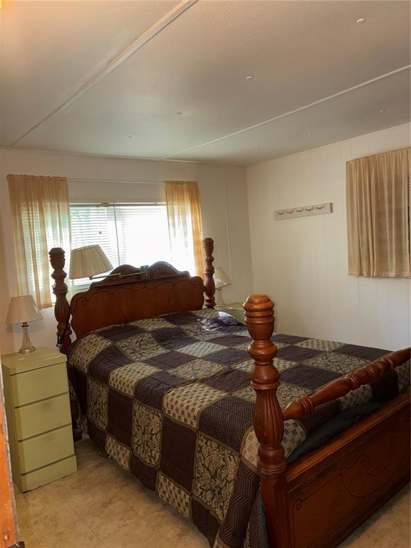 24533 Pink Panther Road Paisley, FL 32767 - Photo 17 of 29 a bedroom with a bed and window