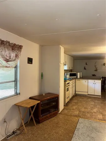 a kitchen with a cabinets and white appliances