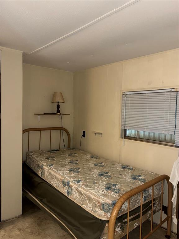 24533 Pink Panther Road Paisley, FL 32767 - Photo 20 of 29 a bedroom with a bed and the table