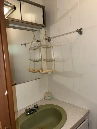 a bathroom with a tub sink and shower