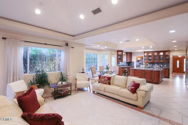 a kitchen with stainless steel appliances granite countertop a sink a stove and a refrigerator