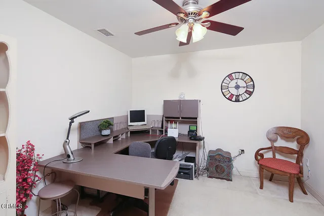 a view of a patio with table and chairs under an umbrella