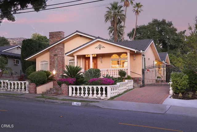 a front view of a house with a garden