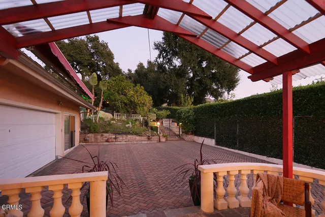 a backyard of a house with table and chairs