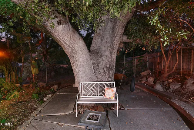 an aerial view of residential houses with outdoor space and trees