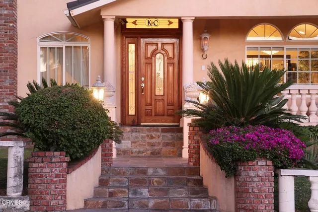 a front view of a house with garden