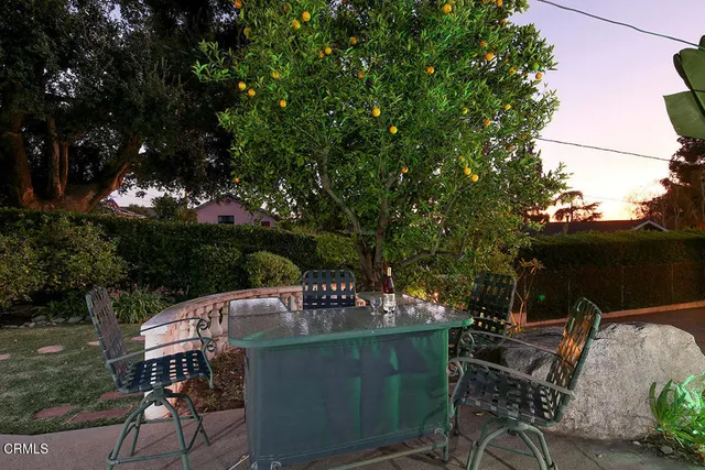 an aerial view of a house with garden space and street view