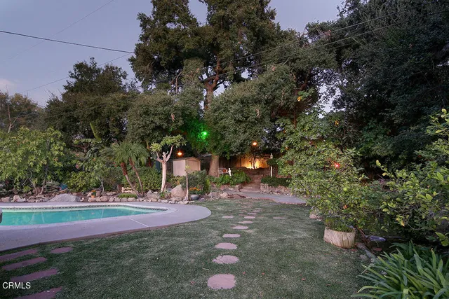 a yellow and red sign sitting on the side of a road
